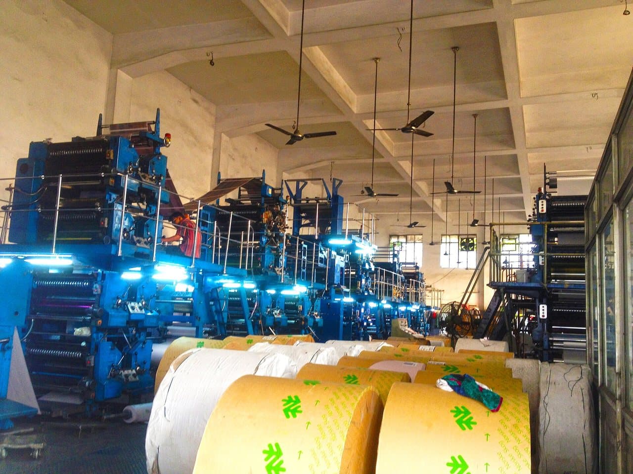 Offset presses and rolls of newsprint in a newspaper's printing hall