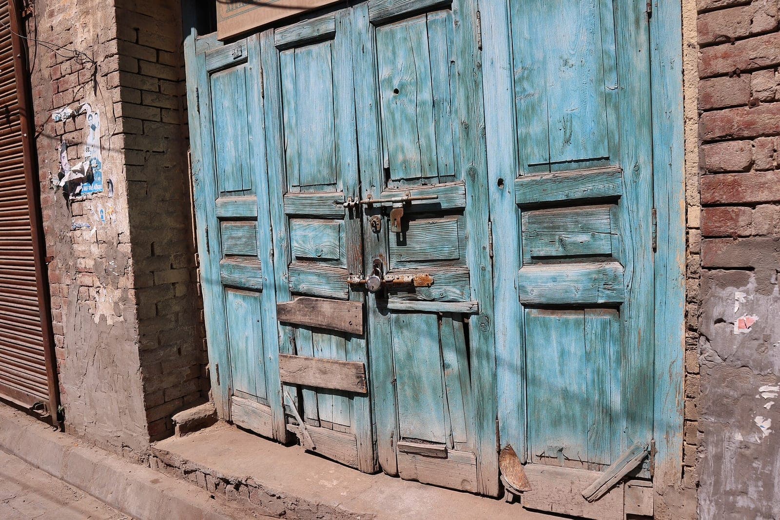 A locked blue wooden door in Amritsar